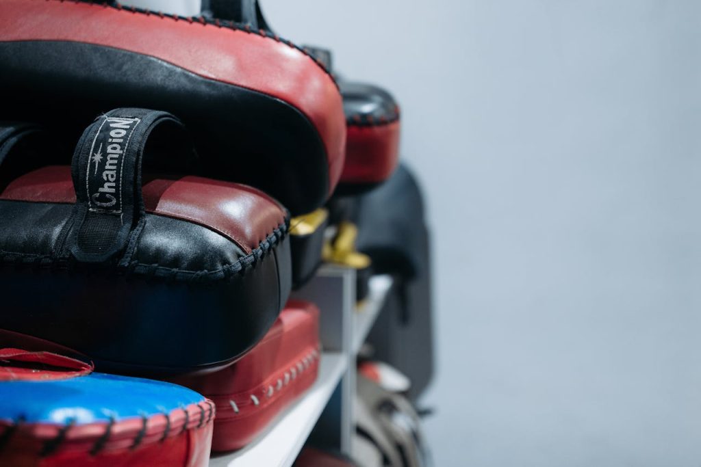 Detailed shot of focus mitts stacked in a gym, showcasing training equipment.